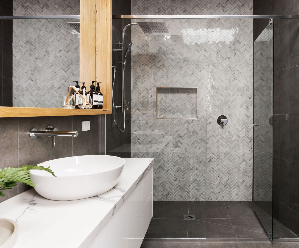 A renovated bathroom with light and dark gray tiles